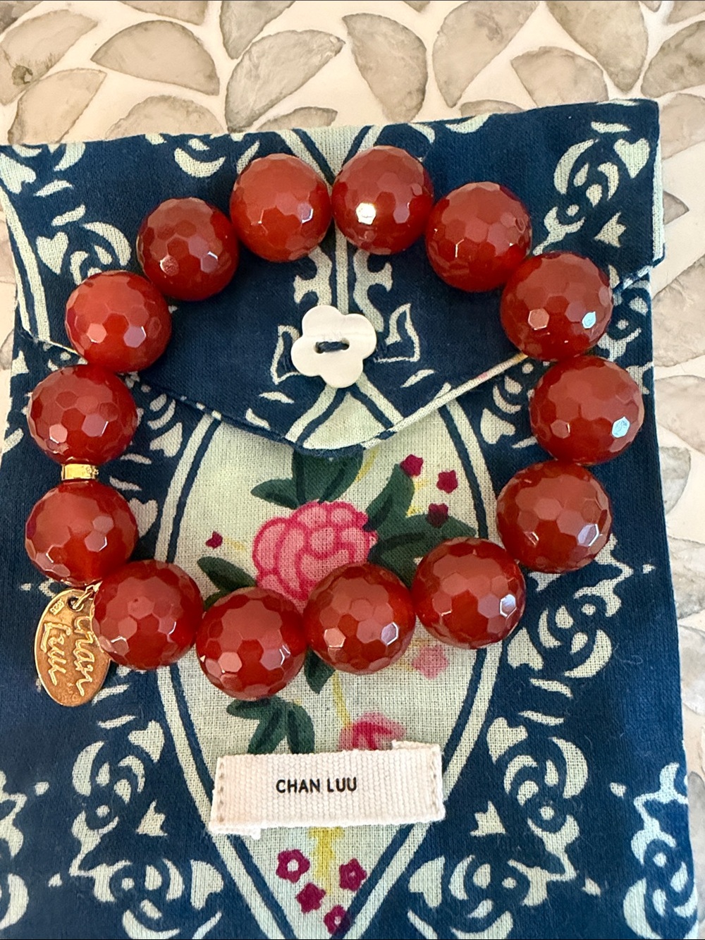 Chan Luu Faceted Red Bead Stretch Bracelet with Gold Logo Charm